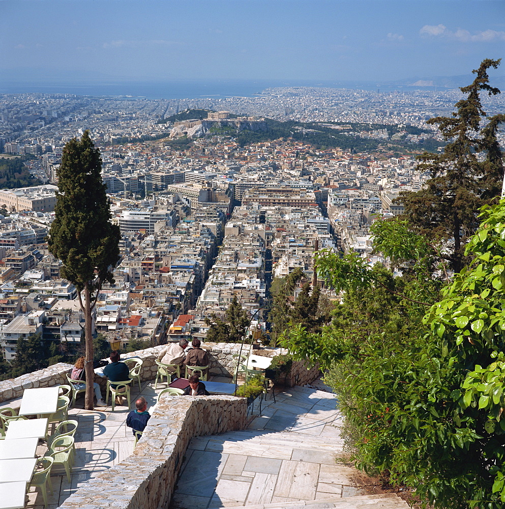 Terrace restaurant on Lykabettos Hill with panorama of the city of Athens including the Acropolis in the background, Greece, Europe