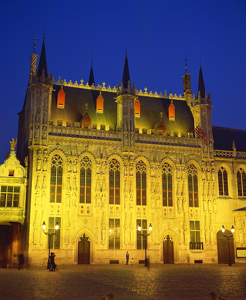 The illuminated facade of the Town Hall in Burg Square in Bruges, at night, Belgium, Europe