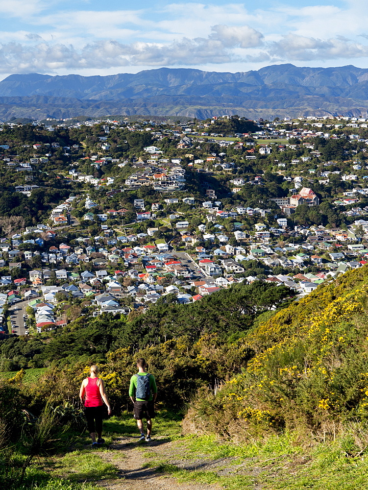 Suburbs and Rimutaka Ranges from Kingston with couple on walking track, Wellington, North Island, New Zealand, Pacific