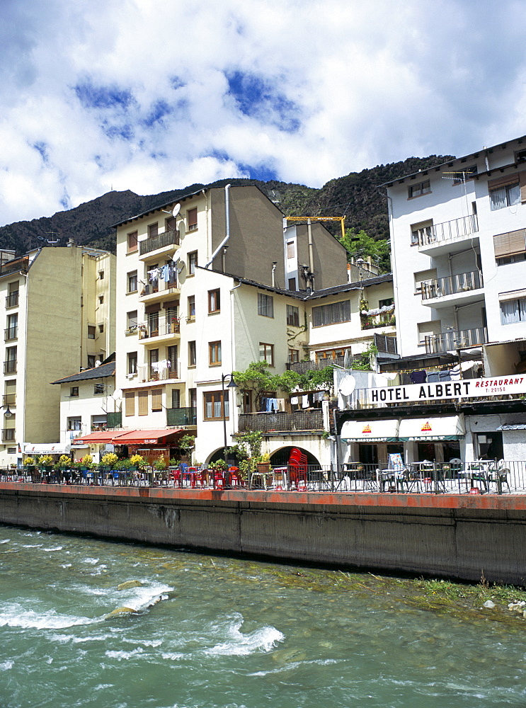 Street cafes on the bank of Riu Valira which runs through the capital city, Andorra la Vella, Andorra, Europe