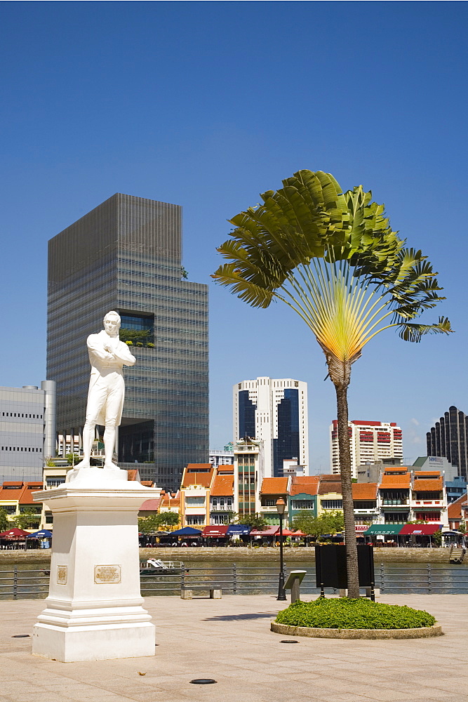 Sir Stamford Raffles statue and travellers palm at Raffles Landing Site on North Boat Quay of River with skyscrapers of Raffles Place in downtown Central Business District beyond, Marine Parade, Singapore, Southeast Asia, Asia