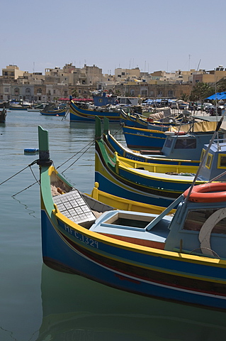 Brightly coloured fishing boats called Luzzus at the fishing village of Marsaxlokk, Malta, Mediterranean, Europe