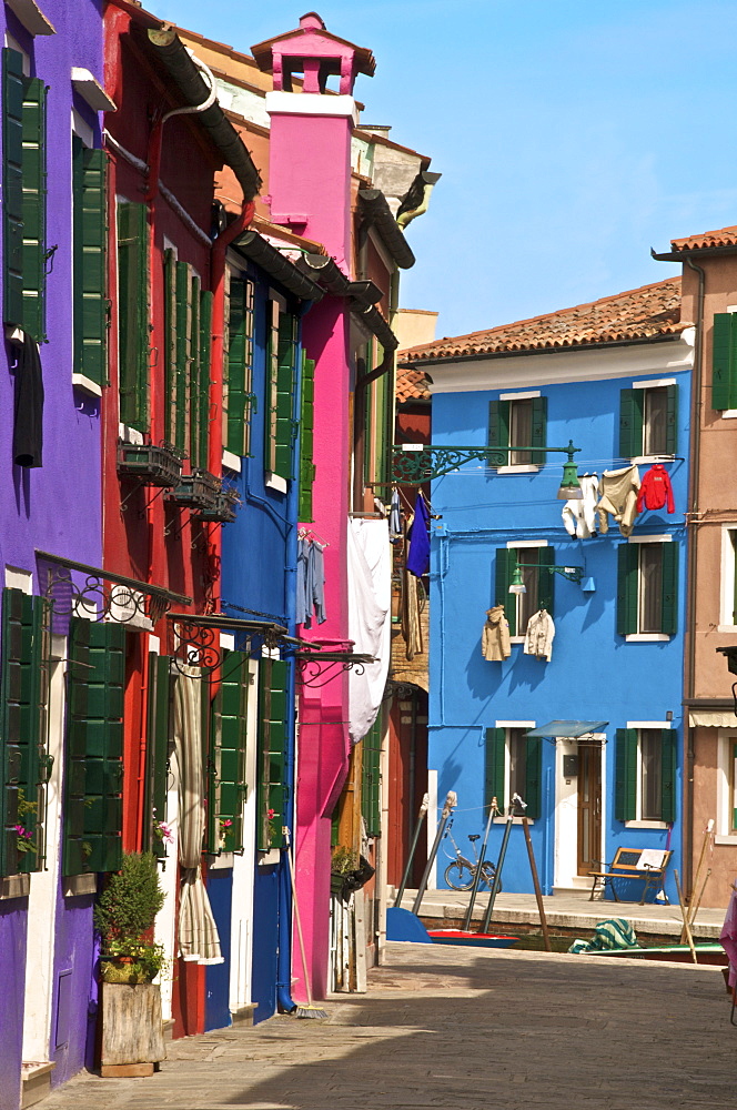 A street with washing drying at windows, Burano Island, Venice, Veneto, Italy, Europe