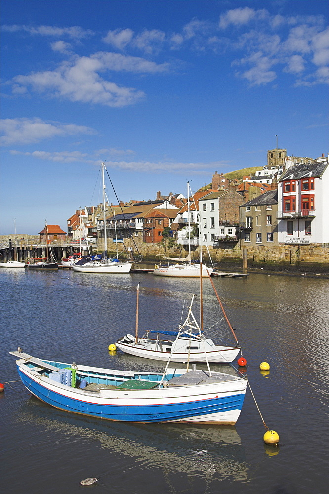 Whitby church and fishing boats in the harbour, Whitby, North Yorkshire, Yorkshire, England, United Kingdom, Europe