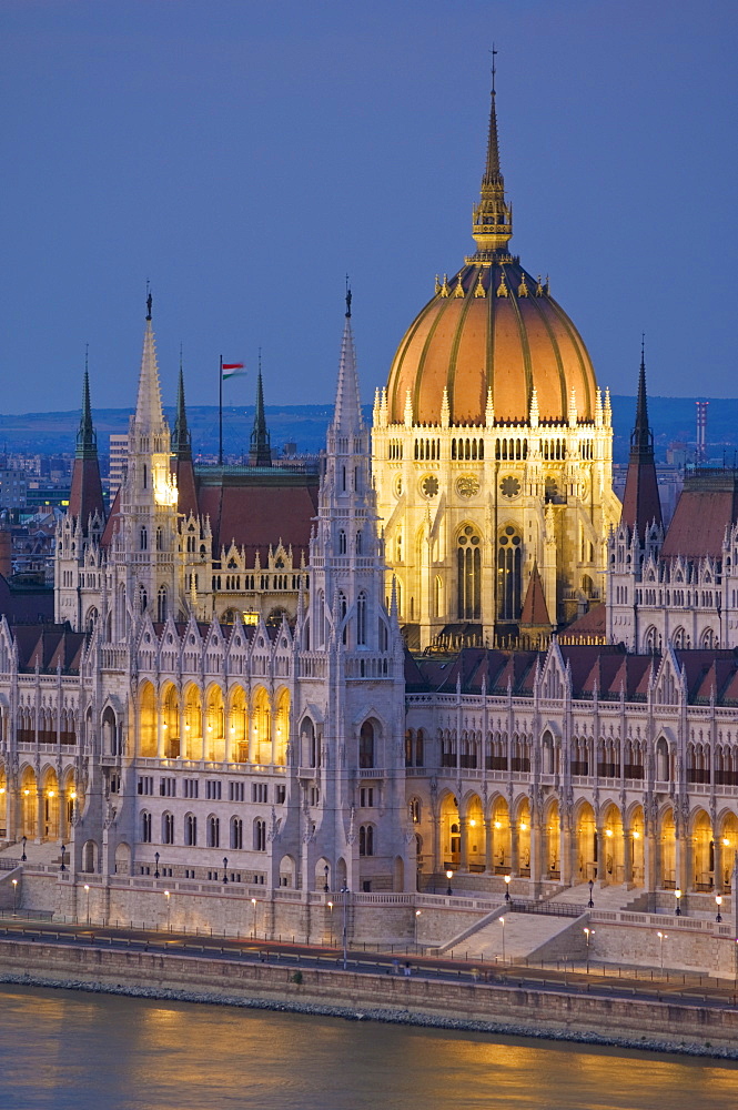 The neo-gothic Hungarian Parliament building, designed by Imre Steindl, illuminated at night, and the River Danube, UNESCO World Heritage Site, Budapest, Hungary, Europe