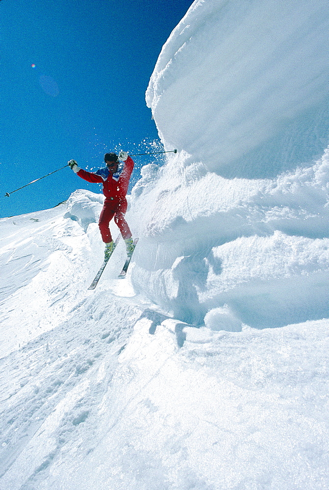 France, Alps, Haute-Savoie, Megeve In Winter, Skier Jumping From A Snow Bergschrund