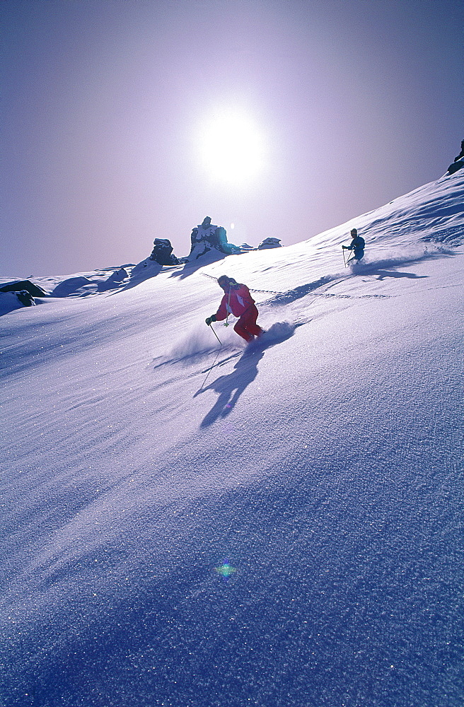 France, Alps, Savoie, Val Thorens In Winter, Man & Woman Skiing, Counterlight