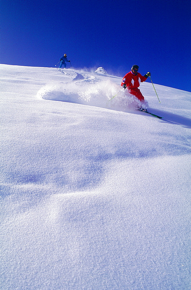 France, Alps, Savoie, Val Thorens In Winter, Man & Woman Skiing