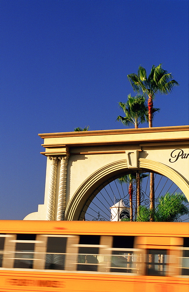 Usa, California, Los Angeles, Melrose, Blurred Schoolbus Passing By Paramount Studios Portal