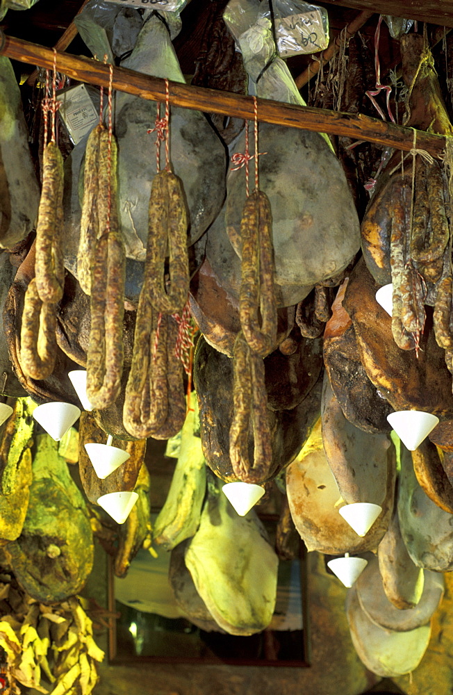 France, Corsica Island, Corse-Du-Sud, Porto-Vecchio, L'orriu Shop Of Corsican Fine Products Danielle Andreani Owner, Drying Hams Suspended From The Ceiling