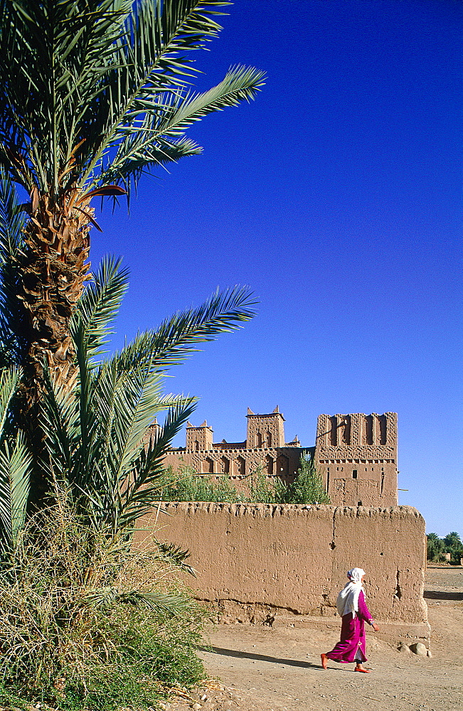 Morocco, South, Ouarzazate Region, Dades Valley, Near The Skoura Oasis The Ameridhil Ksar Ancient Adobe Fortress, Berber Woman Passing By