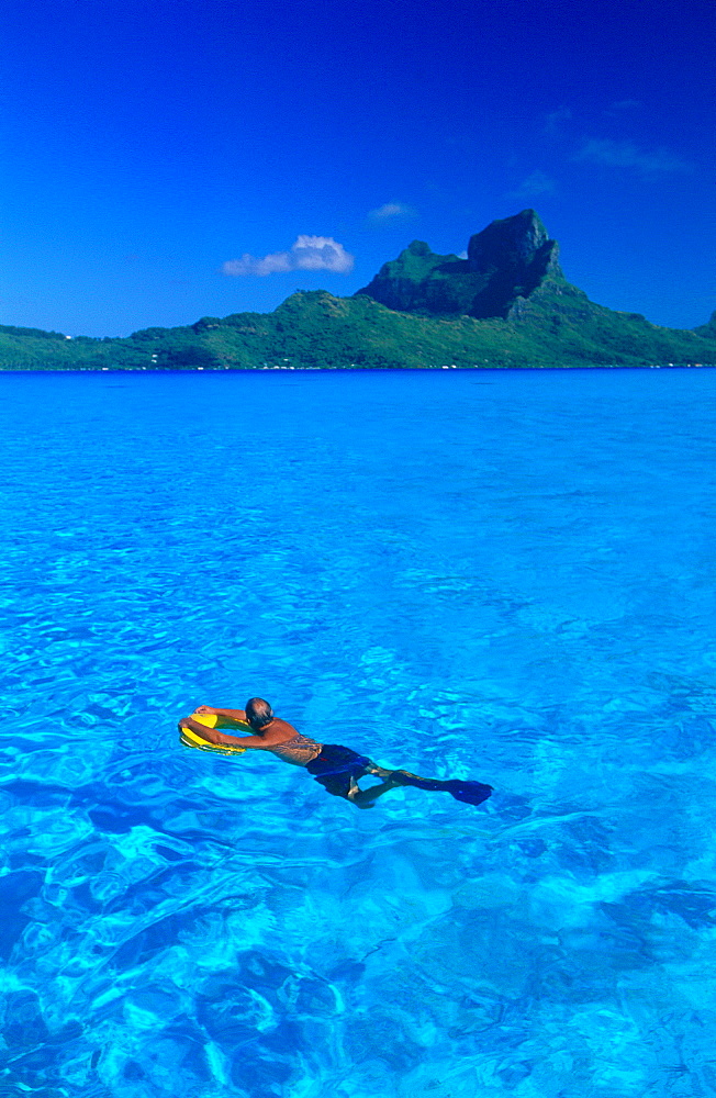 French Polynesia, Leeward Islands, Borabora, Landscape Of The Lagoon With A Swimmer In Foreground