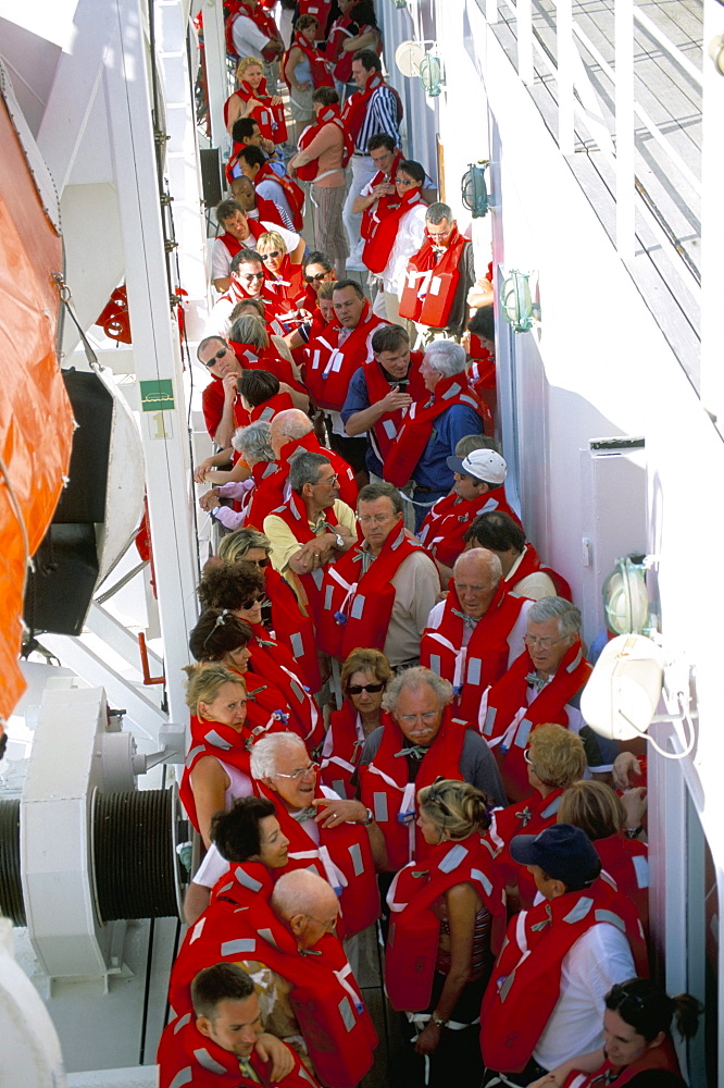 Passengers wearing lifejackets on cruise ship, Mediterranean, Europe