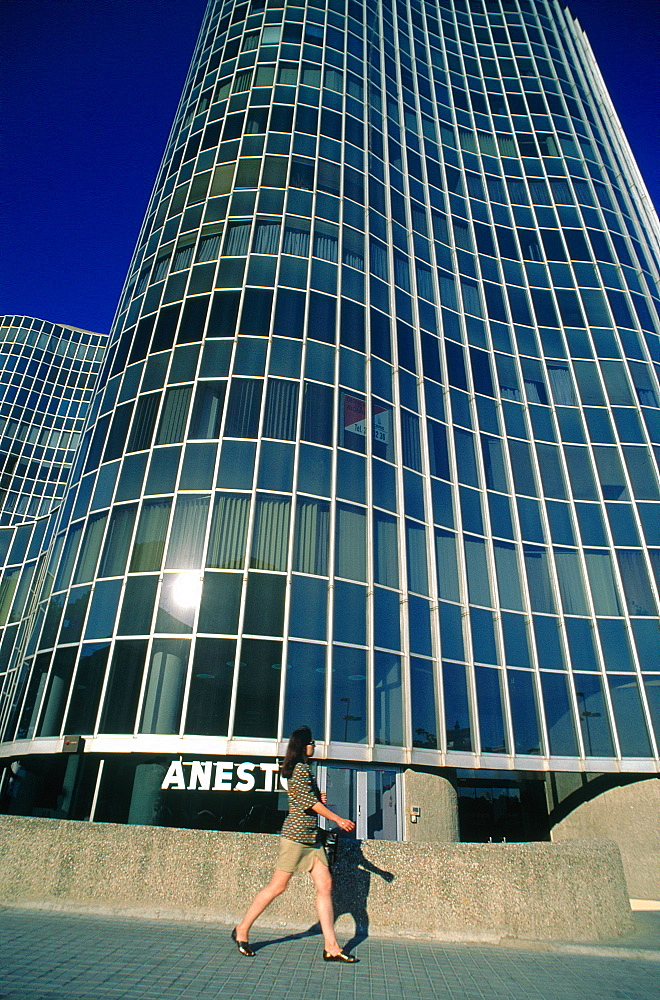 Spain, Catalonia, Barcelona, Diagonal, Modern Offices Building, Young Woman Passing By