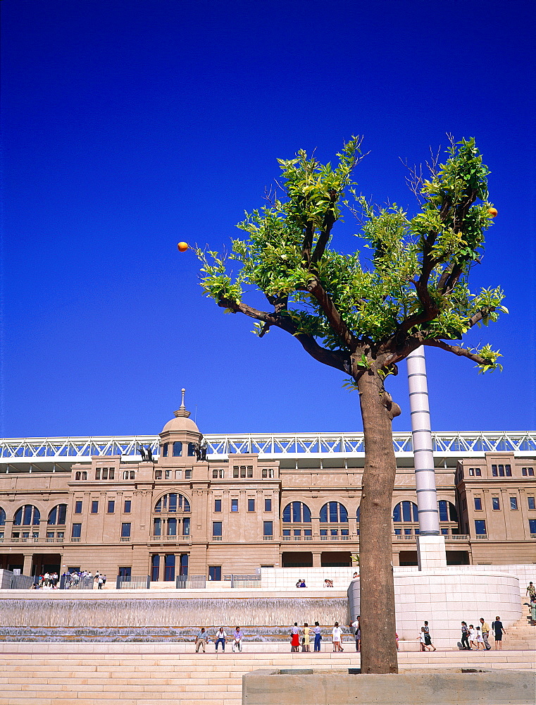 Spain, Catalonia, Barcelona, Facade Of The Olympic Stadium With Orange Tree At Fore