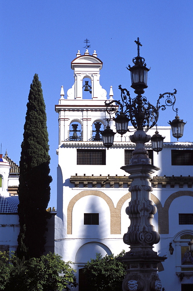 Ornate street lamp and church facade, Seville, Andalucia (Andalusia), Spain, Europe