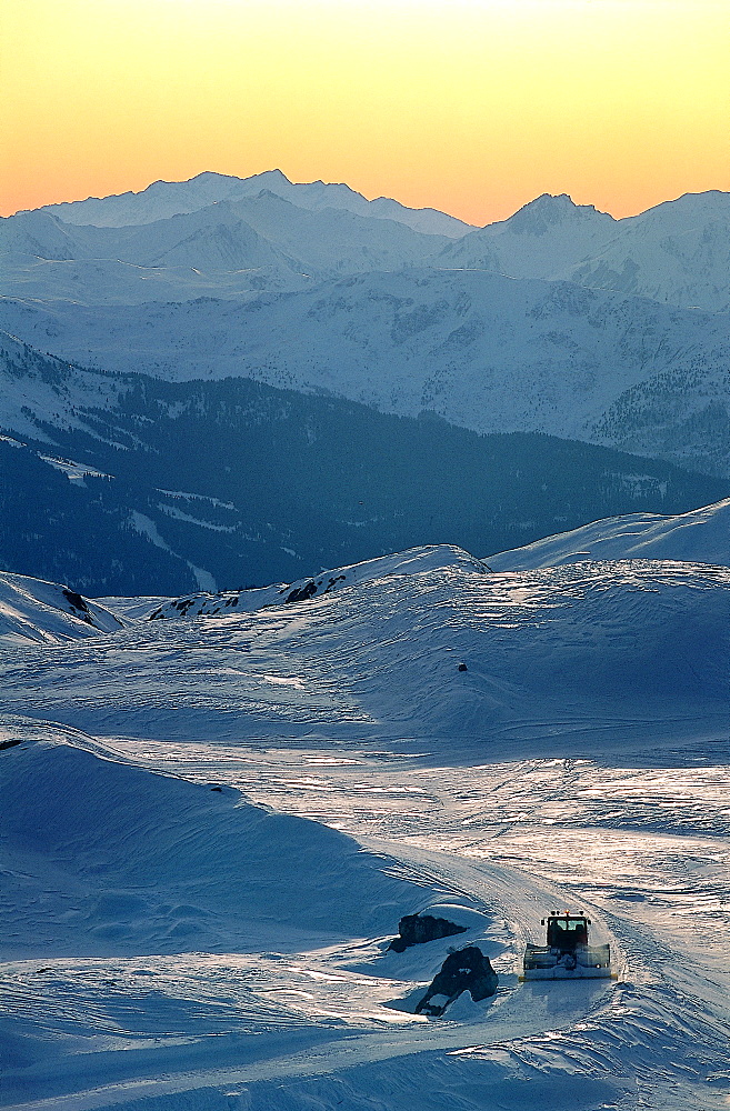 France, Alps In Winter, Overview On Mountains At Dusk, Ski Trail At Fore Being Maintained 