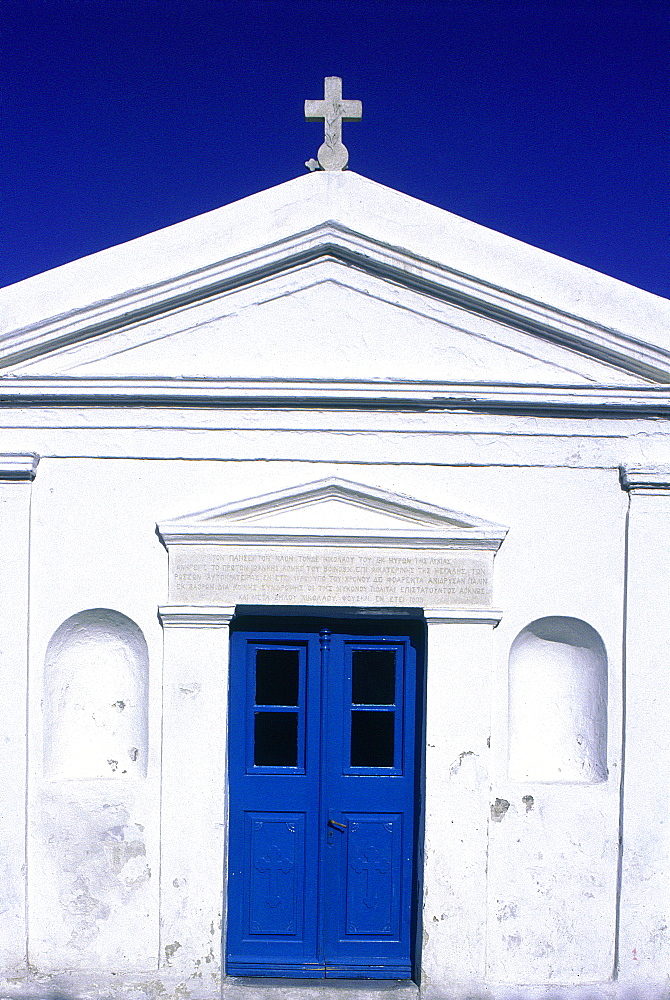 Greece, Cyclades, Mykonos Island, Facade Of A Plain White Chapel, Blue Door And Sky