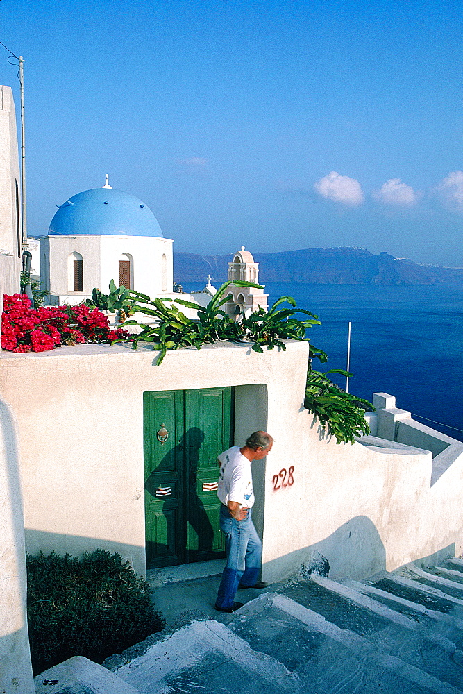 Greece, Cyclades, Santorini Island, Ia Village, Silhouette Of A Man On The Stairs, Chapel Blue Dome At Rear