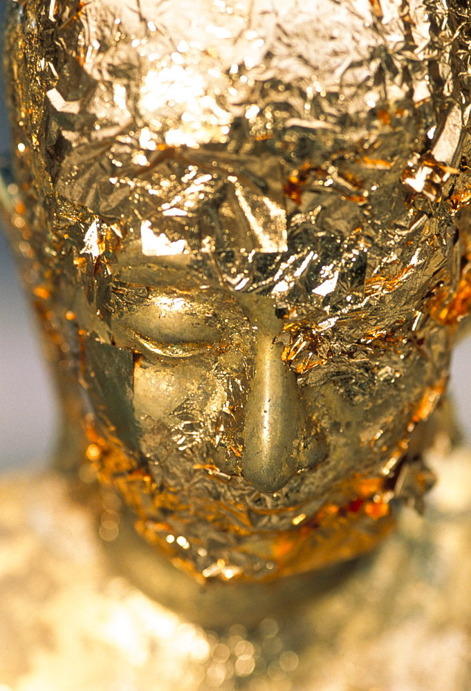 Gold leaf on statue head, Royal Palace, Bangkok, Thailand, Southeast Asia, Asia