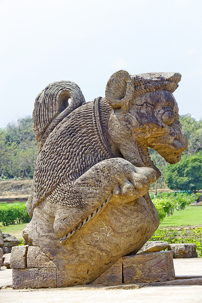 Stone statue of a mythical creature among ruins in the grounds of the mid 13th century Sun Temple, dedicated to Surya, the Hindu Sun God, constructed as a twelve-wheeled chariot drawn by seven horses, UNESCO World Heritage Site, Konarak, Puri District, Odisha, India, Asia