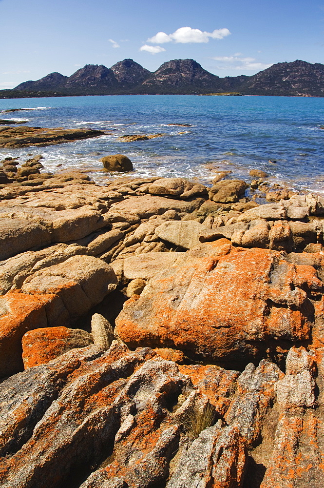 Lichen covered red granite rocks at the Hazards Mountain Range, Coles Bay, Freycinet Peninsula, Freycinet National Park, Tasmania, Australia, Pacific