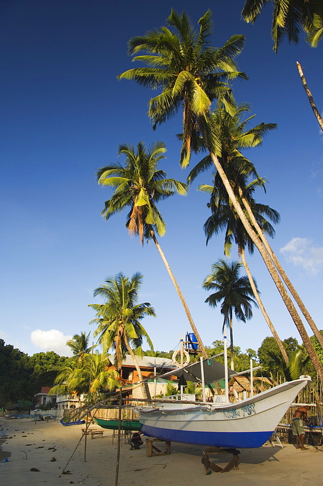 Fishing boat on beach and palm trees, Bacuit Bay, El Nido Town, Palawan Province, Philippines, Southeast Asia, Asia