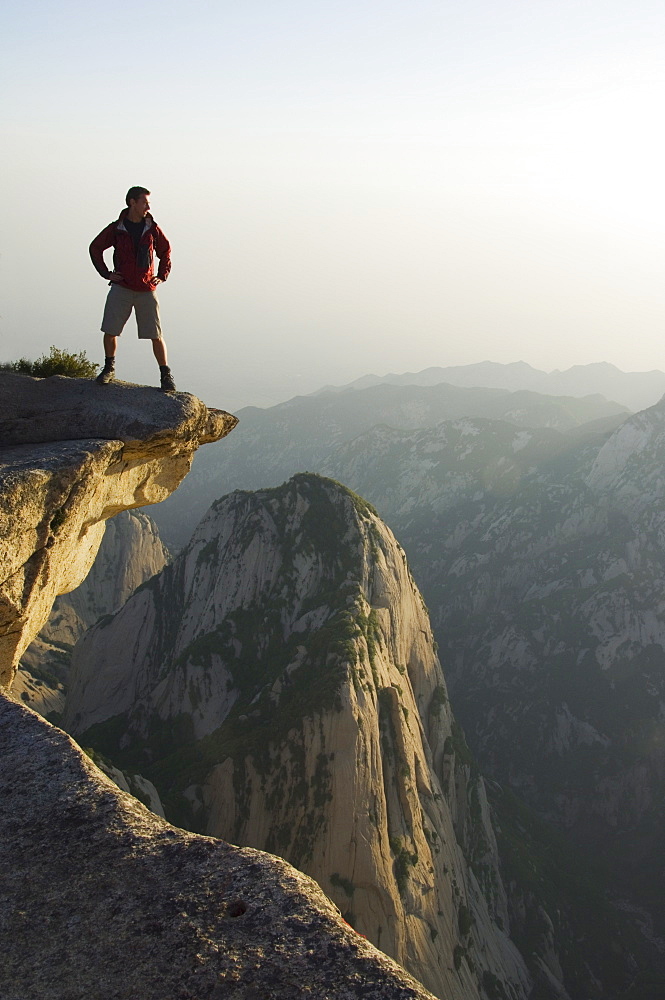 Foreign tourist admiring the view on Hua Shan, a granite peaked mountain of 2160m, Shaanxi Province, China, Asia