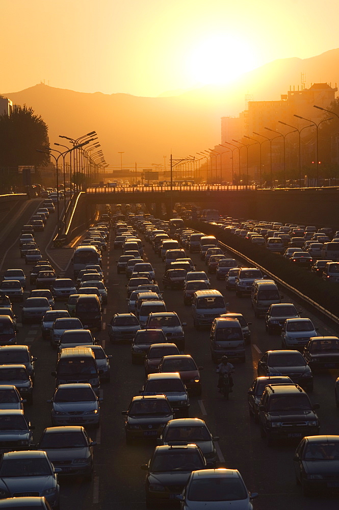 Sunset over city ring road during rush hour, Beijing, China, Asia