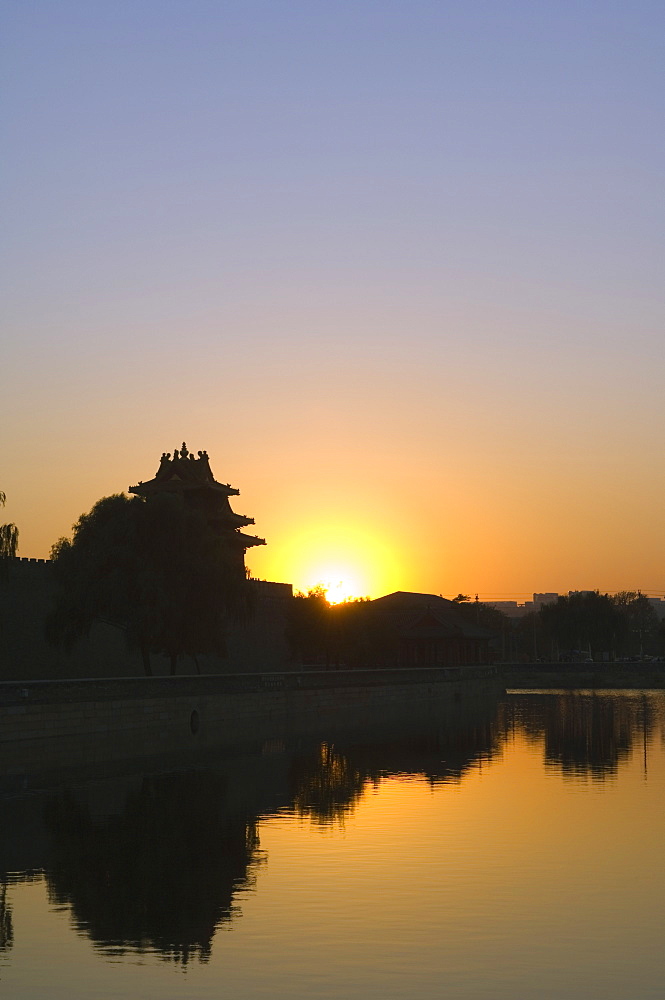 Sunset on a watch tower on the wall of the Forbidden City Palace Museum, Beijing, China, Asia