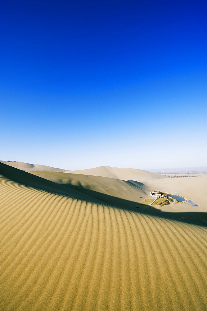 Ming Sha sand dunes and pavilion at Crescent Moon Lake, Dunhuang, Gansu Province, China, Asia