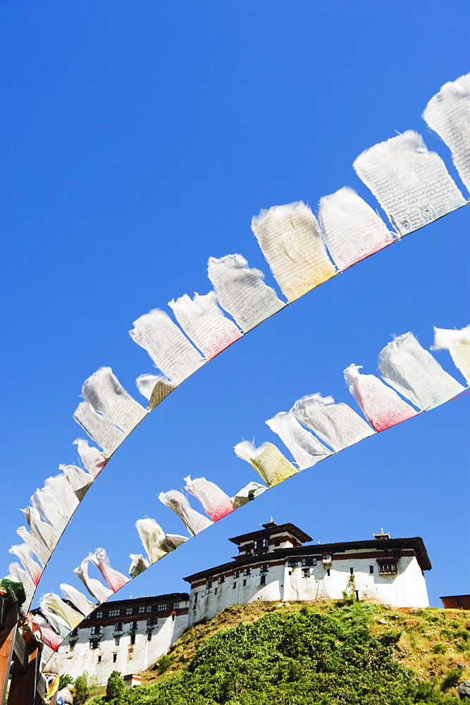 Prayer flags below Wangdue Phodrang Dzong, founded by the Zhabdrung in 1638, Bhutan, Asia