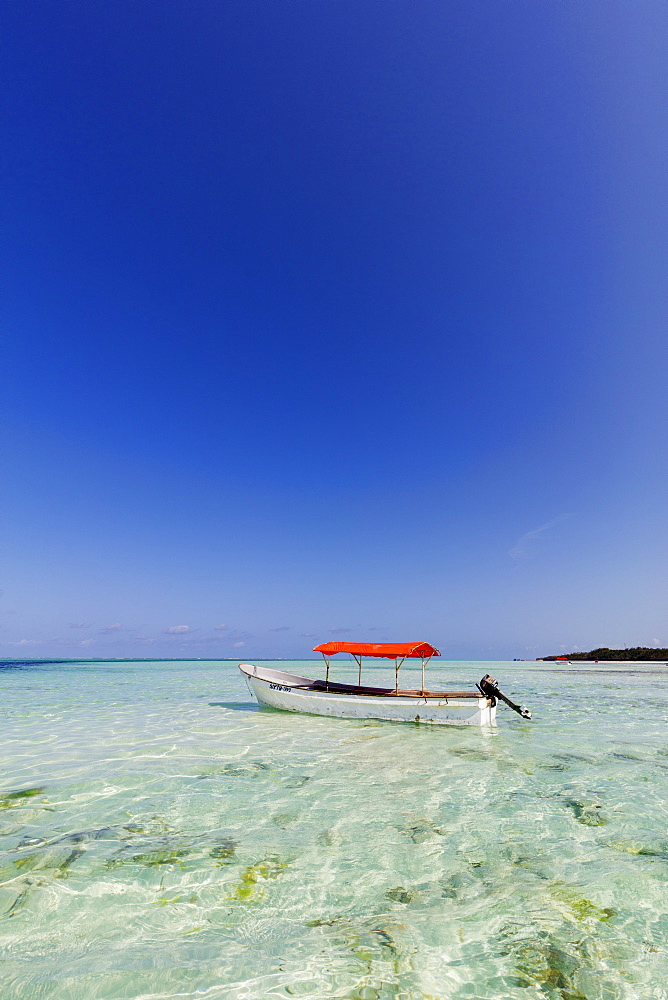 Small boat in crystal clear water, Pingwe, Island of Zanzibar, Tanzania, East Africa, Africa