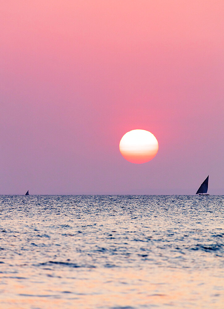 Dhow sailing boat on Indian Ocean at sunset, Stone Town, Zanzibar Island, Tanzania, East Africa, Africa