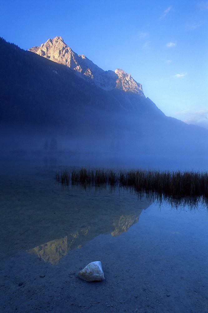 Early morning fog over Ferchensee, Mittenwald, Wetterstein Alps, Germany, Europe