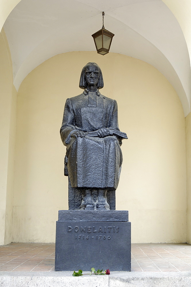 Rose placed at the foot of the statue of Donelaitis 1714-1780, outside the University, Vilnius, Lithuania, Baltic States, Europe