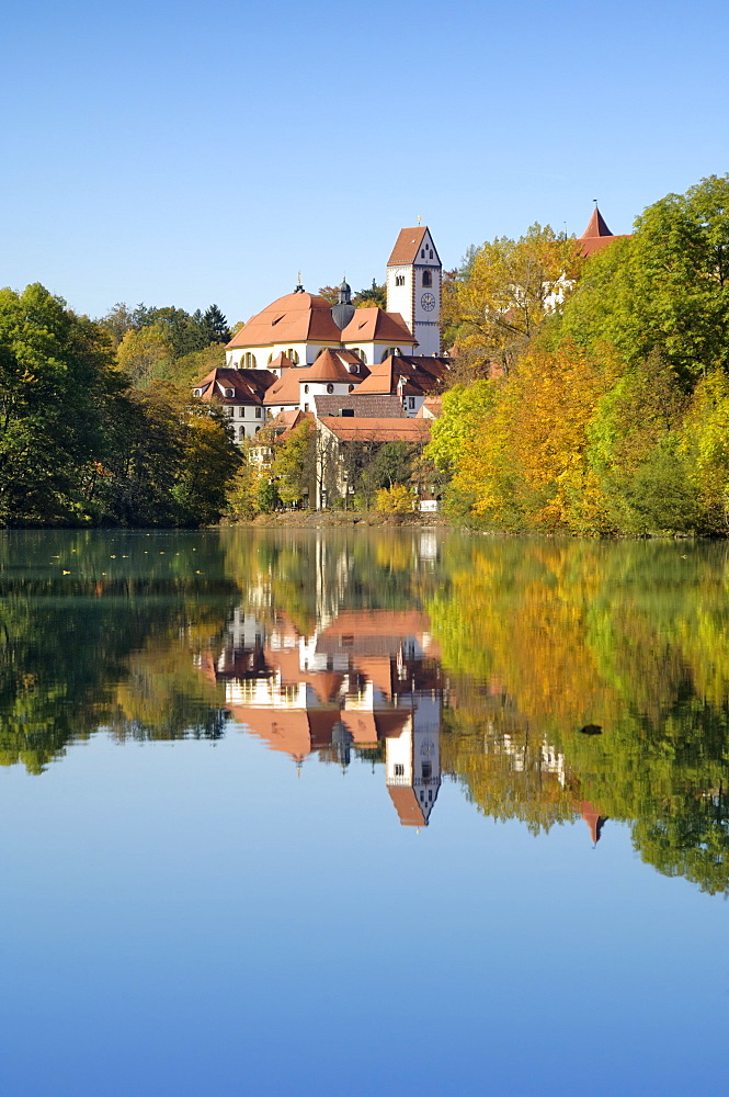 St. Mang Monastery and Basilica reflected in the river Lech, Fussen, Bavaria (Bayern), Germany, Europe