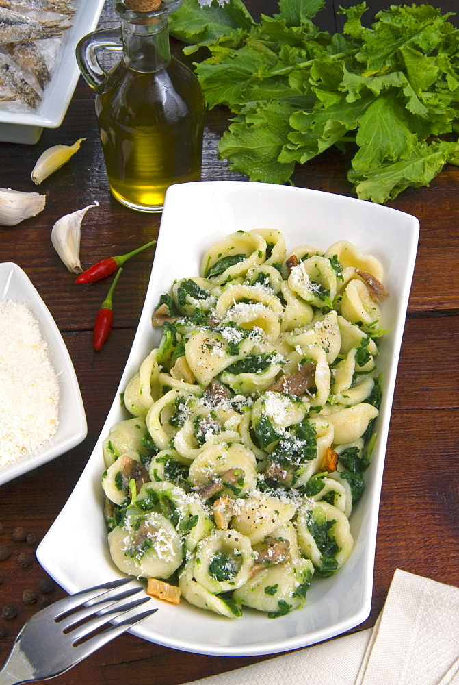 Orecchiette (little ears), a type of pasta of Apulia, with broccoli rabe and salted fish (Orecchiette con cime di rapa), Italy, Europe