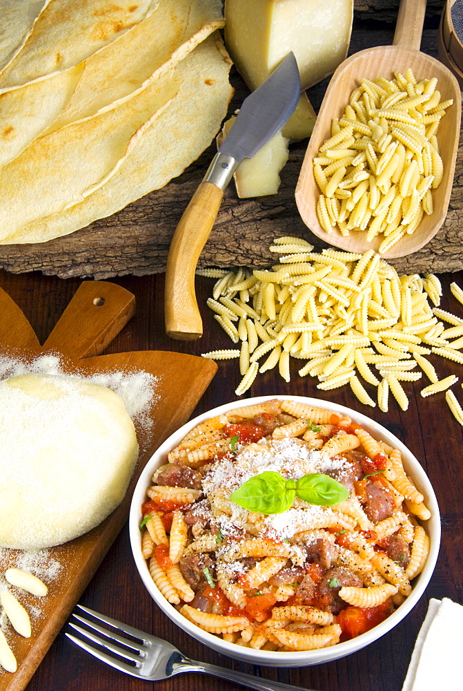 Malloreddus alla Campidanese (Malloreddus with sausage, pecorino cheese and tomato sauce), Sardinian malloreddus, Carasau bread, Pattada Sardinian knife, Sardinia, Italy, Europe