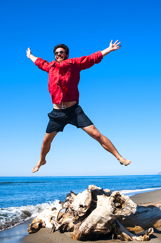 Jumping close to sea, Capalbio beach, province of Grosseto, Tuscany, Italy, Europe