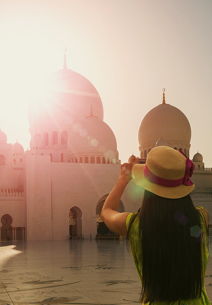 Woman photographing Sheikh Zayed Grand Mosque, Abu Dhabi, United Arab Emirates, Middle East