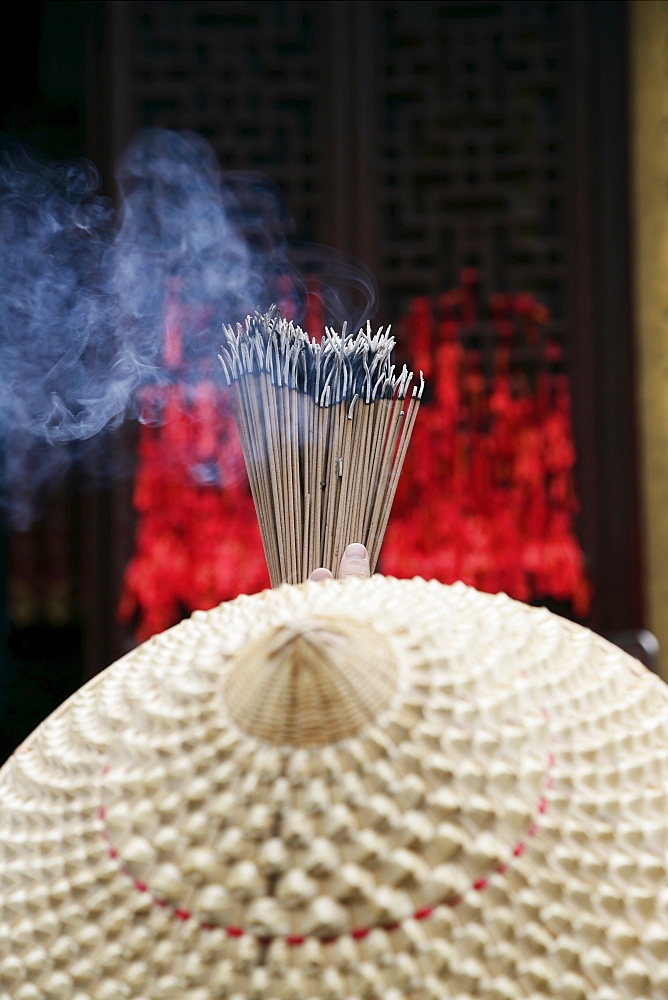 Chinese woman with incense sticks, Jade Buddha Temple, Shanghai, China, Asia