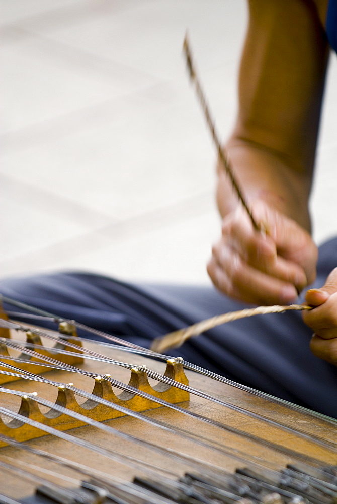 Street musician playing instrument, Kunming, Yunnan, China, Asia