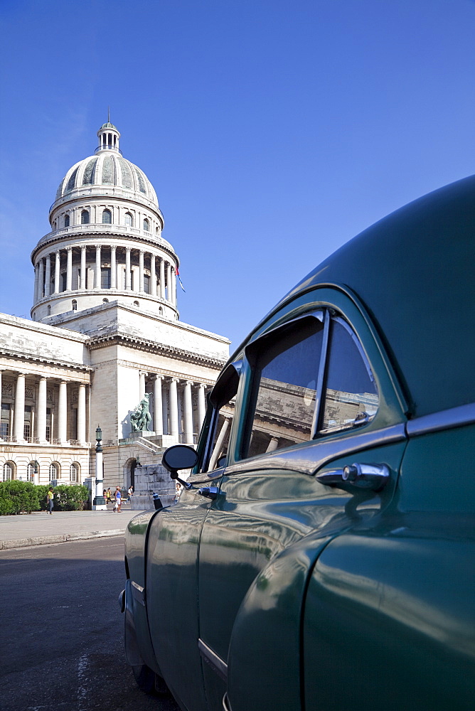 Old American car parked near the Capitolio building, Havana, Cuba, West Indies, Central America