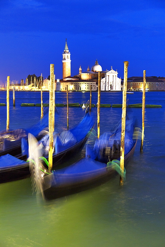 Gondolas moored in St. Mark's Basin in the evening with San Giorgio Maggiore in the distance, Venice, UNESCO World Heritage Site, Veneto, Italy, Europe