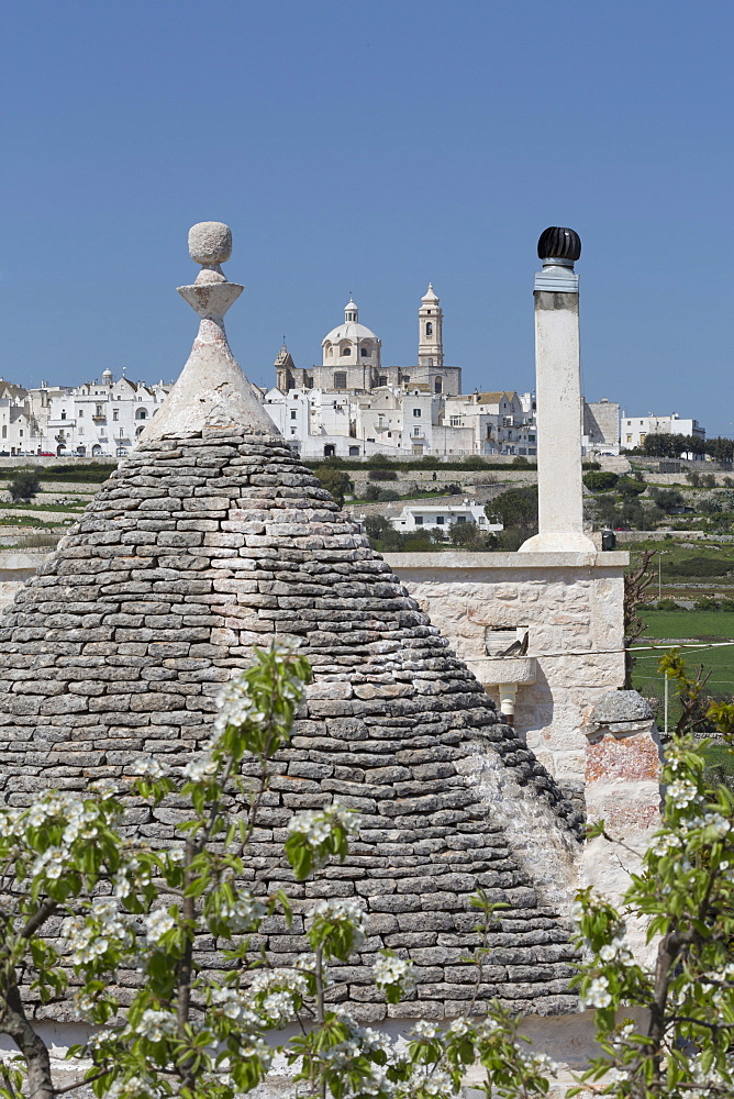 Roof of traditional trullo with Locorotondo in distance, Puglia, Italy, Europe