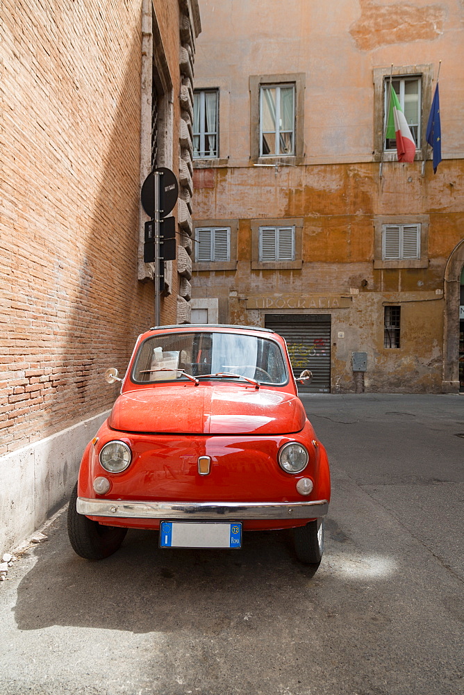 Small old Fiat 500 car parked on a back street in Rome, Lazio, Italy, Europe