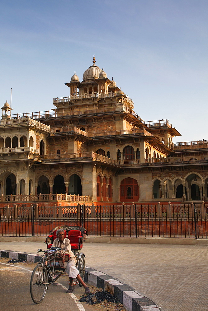 Rickshaw rider resting outside the ornate Albert Hall museum in the city of Jaipur, Rajasthan, India, Asia