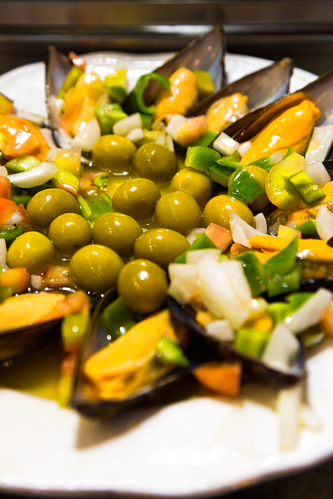 A plate of mussels and olives at a traditional tapas bar in Madrid, Spain, Europe