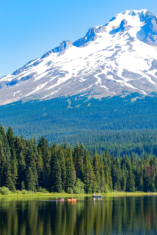 Canoes and rowboat on the still waters of Trillium Lake with Mount Hood, part of the Cascade Range, Oregon, United States of America, North America